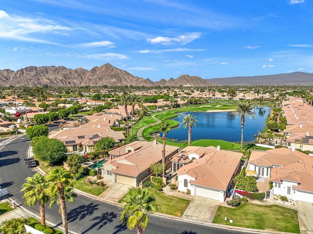 birds eye view of property with a water and mountain view