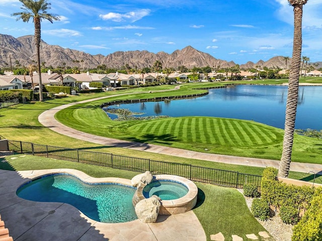 view of swimming pool featuring an in ground hot tub and a water and mountain view