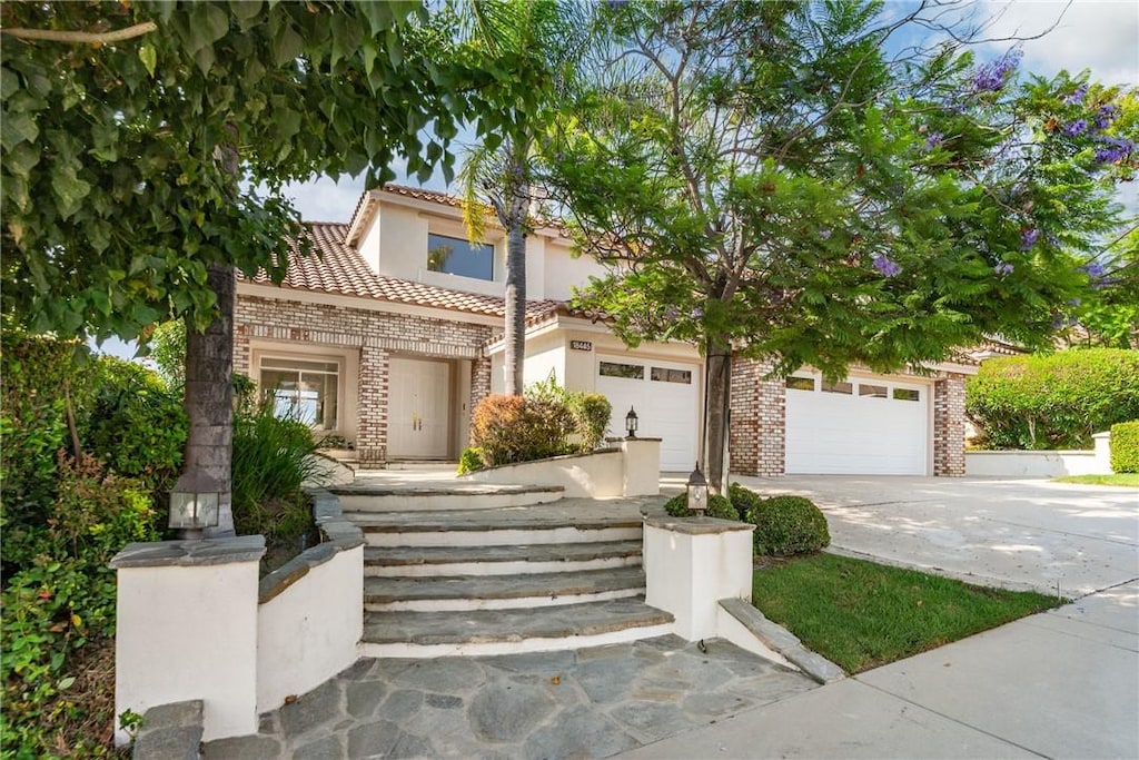 mediterranean / spanish-style home featuring a garage