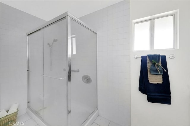 bathroom featuring tile patterned floors and a shower with door