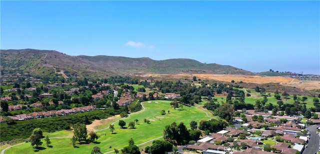 aerial view with view of golf course and a mountain view