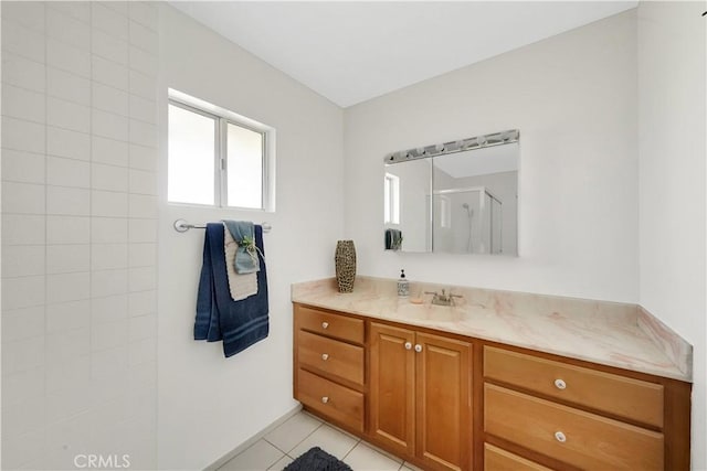 bathroom with tile patterned flooring, vanity, and an enclosed shower