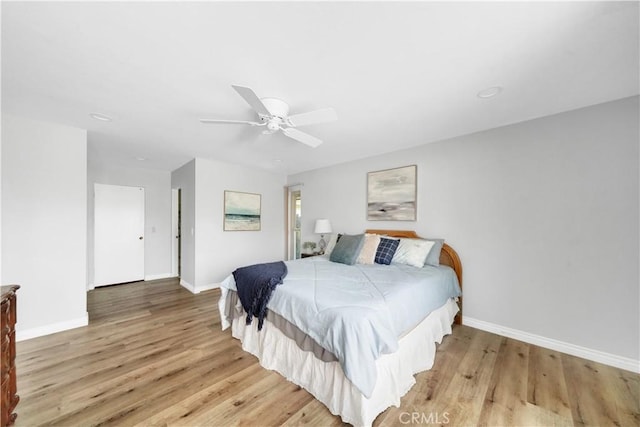 bedroom with light hardwood / wood-style flooring and ceiling fan