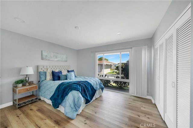 bedroom with light wood-type flooring and a closet