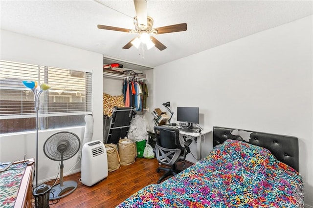 bedroom featuring ceiling fan and dark wood-type flooring