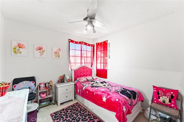 carpeted bedroom with ceiling fan and a textured ceiling