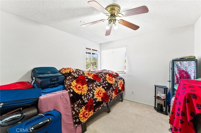 carpeted bedroom featuring a textured ceiling and ceiling fan