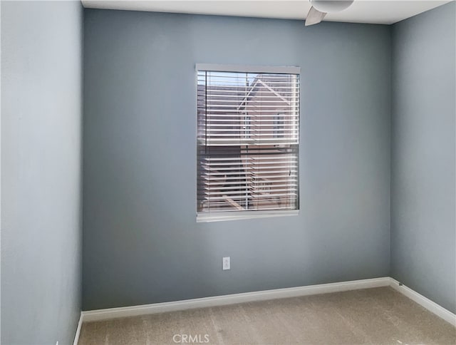 unfurnished room with carpet and ceiling fan