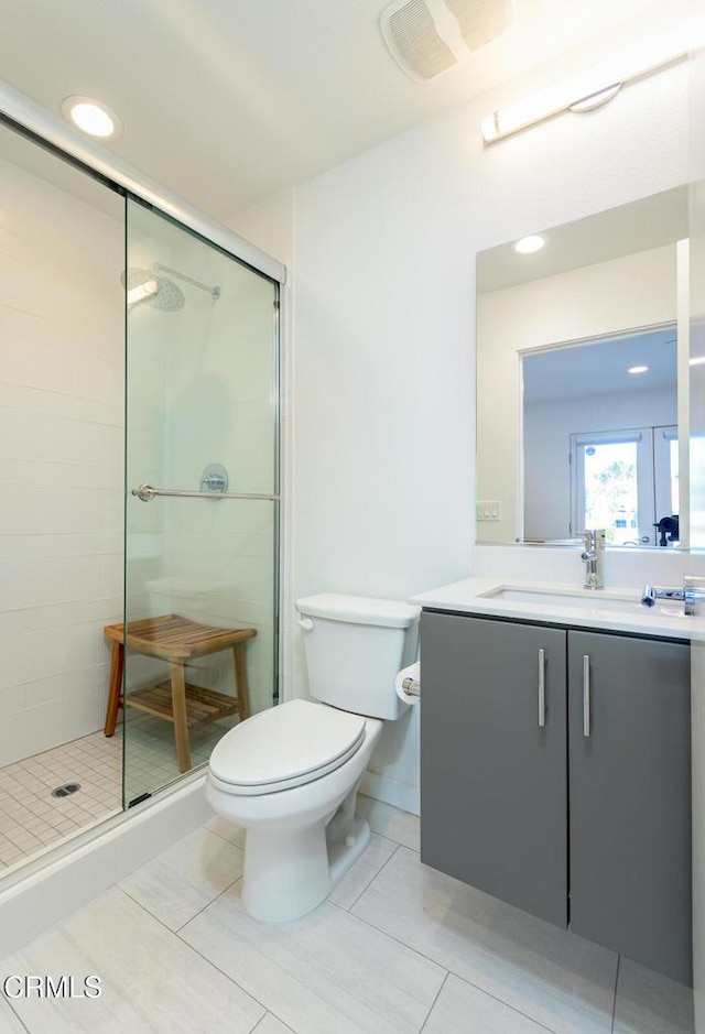 full bathroom with a stall shower, vanity, tile patterned floors, toilet, and recessed lighting