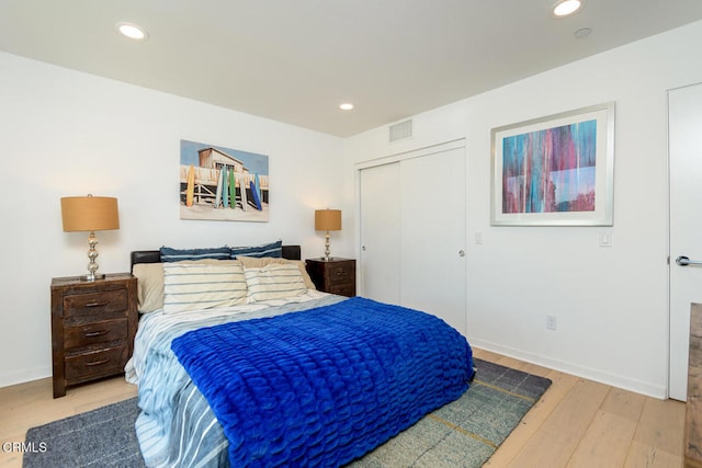 bedroom featuring light hardwood / wood-style floors and a closet