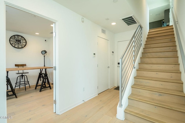 stairs with wood-type flooring