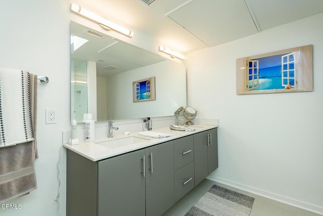 full bath featuring double vanity, a sink, baseboards, and visible vents