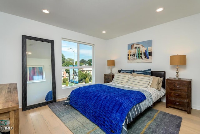 bedroom with recessed lighting, baseboards, and wood finished floors