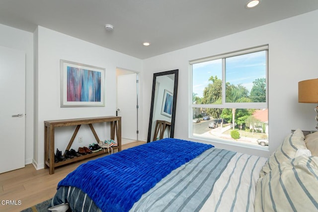 bedroom featuring light wood-type flooring, recessed lighting, and baseboards