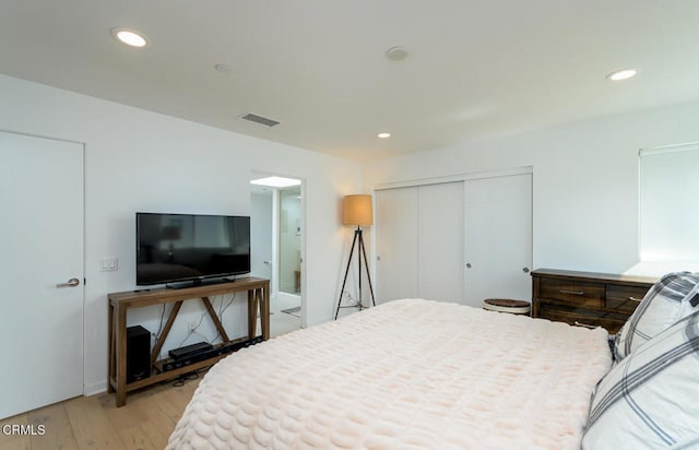 bedroom featuring light hardwood / wood-style flooring and a closet