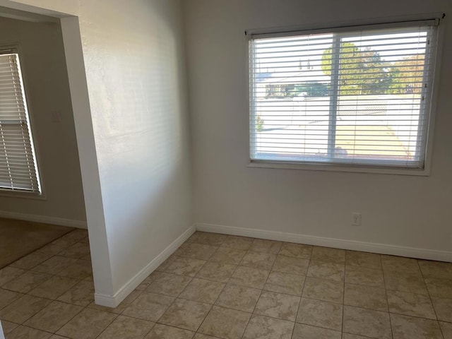 unfurnished room featuring light tile patterned floors