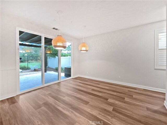 unfurnished room featuring hardwood / wood-style flooring