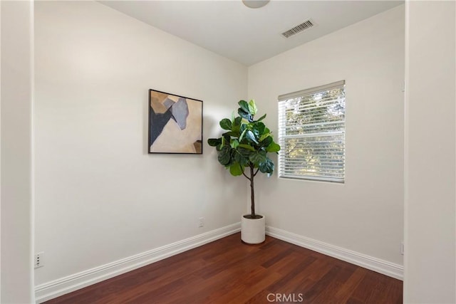 unfurnished room featuring dark wood-type flooring