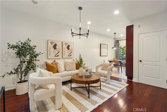 living room featuring dark hardwood / wood-style floors and a notable chandelier