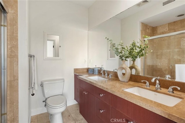 bathroom with tile patterned floors, vanity, toilet, and walk in shower