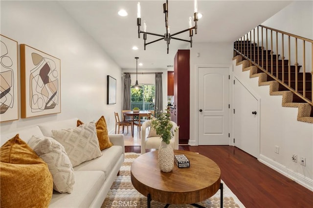 living room featuring wood-type flooring and an inviting chandelier