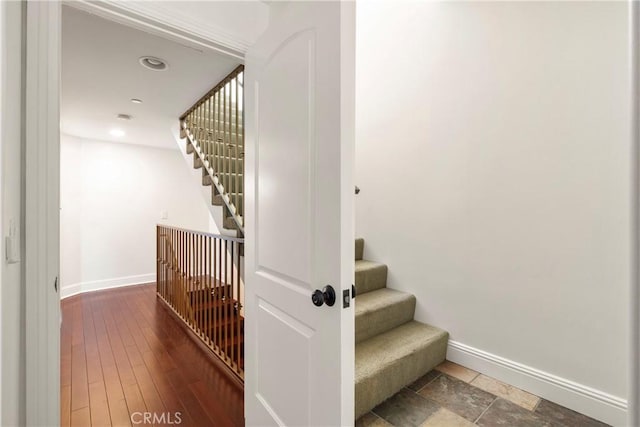 staircase with hardwood / wood-style floors