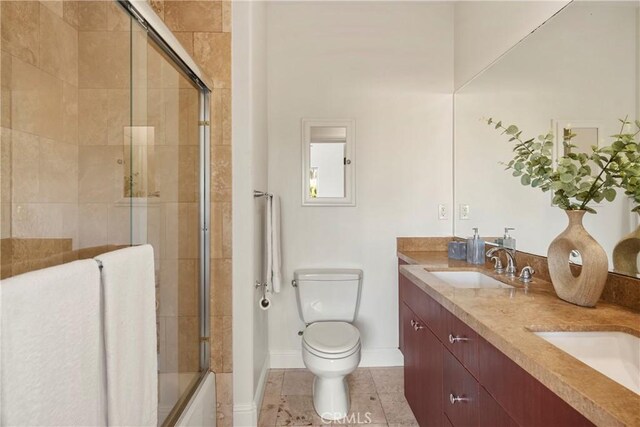 full bathroom with shower / bath combination with glass door, vanity, and toilet