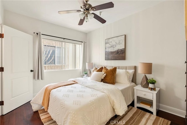 bedroom with ceiling fan and dark hardwood / wood-style flooring