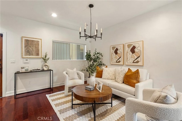 living room with a notable chandelier and dark wood-type flooring