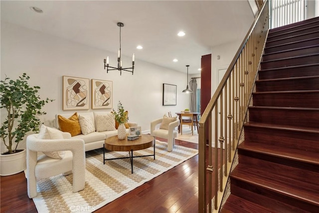 living room with hardwood / wood-style floors and a chandelier