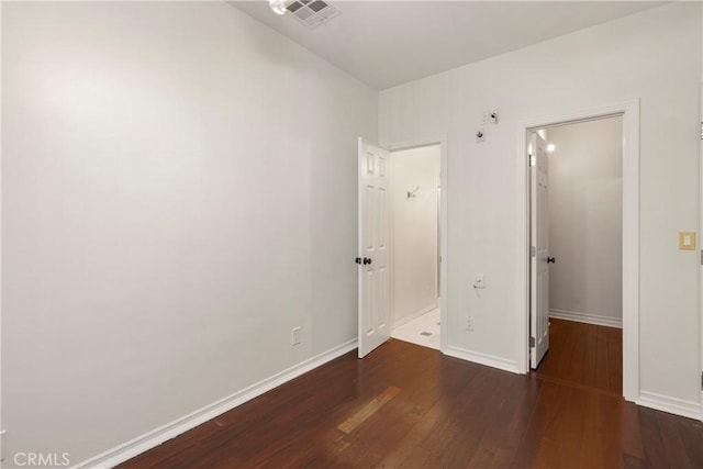 unfurnished bedroom featuring dark hardwood / wood-style floors