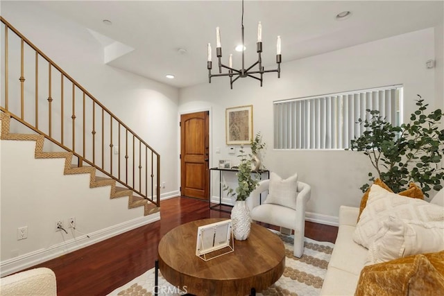 living area with hardwood / wood-style floors and a notable chandelier