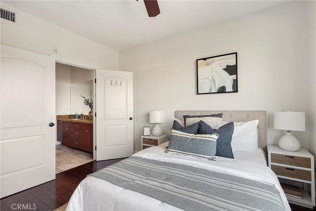 bedroom featuring ceiling fan, dark hardwood / wood-style flooring, and ensuite bathroom