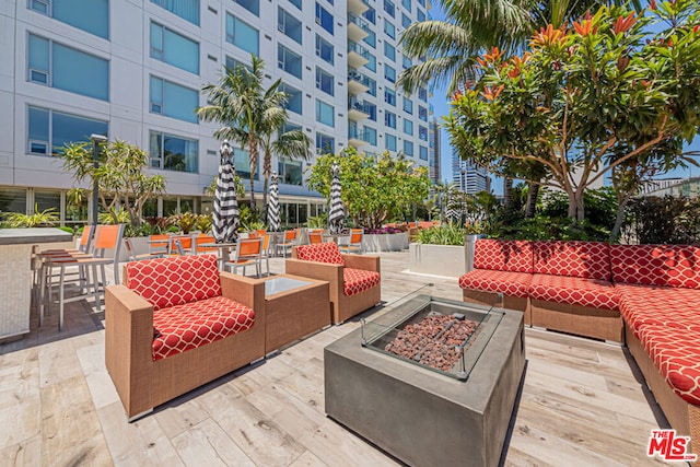 view of patio / terrace with an outdoor living space with a fire pit