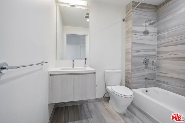 full bathroom featuring vanity, toilet, and tiled shower / bath