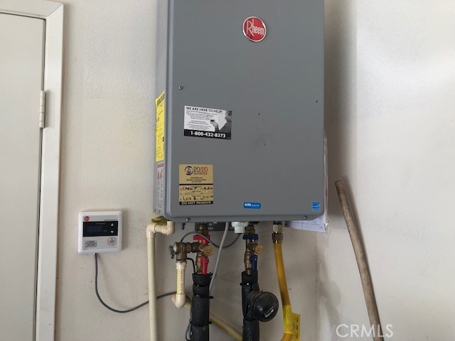 utility room featuring water heater