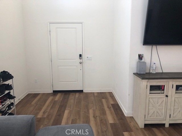 entryway with dark hardwood / wood-style flooring