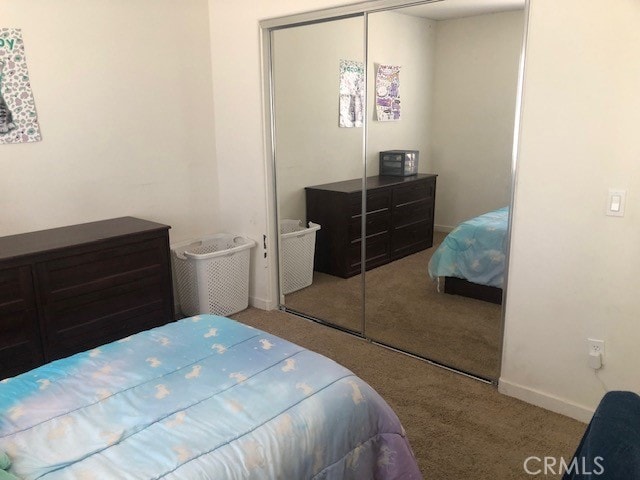 carpeted bedroom featuring a closet