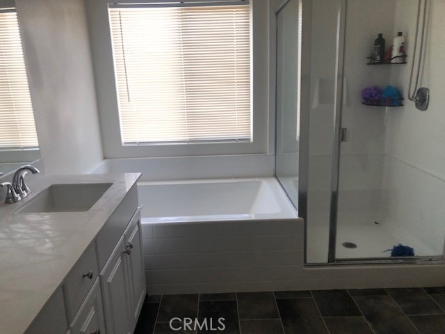 bathroom featuring vanity, tile patterned floors, and shower with separate bathtub