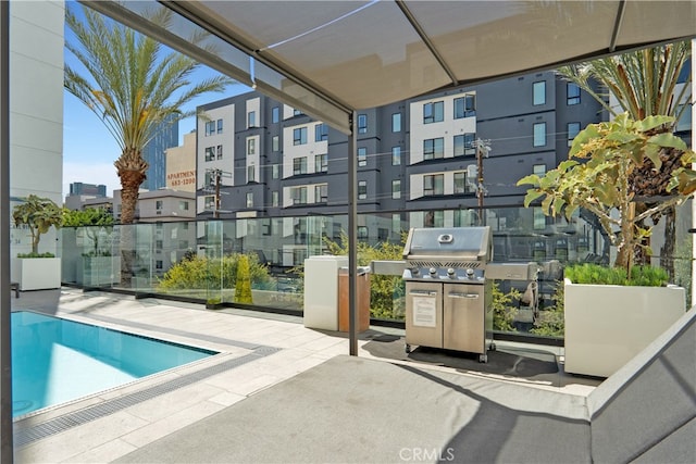 view of swimming pool with area for grilling and a patio area