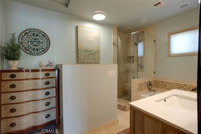 bathroom with tile patterned floors, vanity, and a shower with shower door