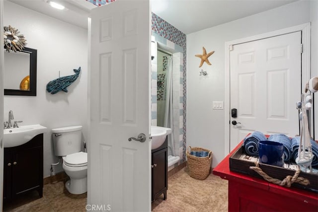 bathroom with walk in shower, tile patterned floors, vanity, and toilet