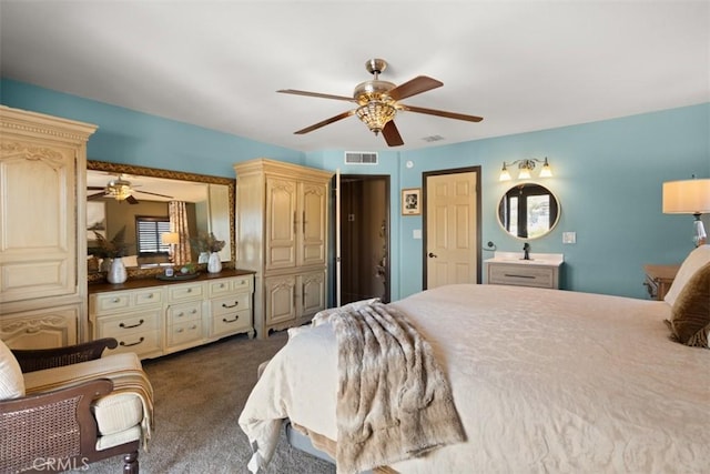 bedroom with ceiling fan and dark carpet