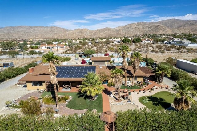 birds eye view of property featuring a mountain view