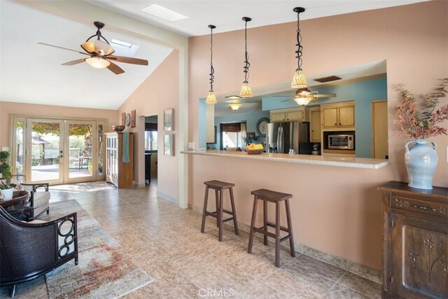 kitchen with stainless steel appliances, ceiling fan, french doors, and pendant lighting