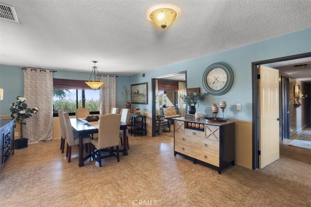 dining area with a textured ceiling