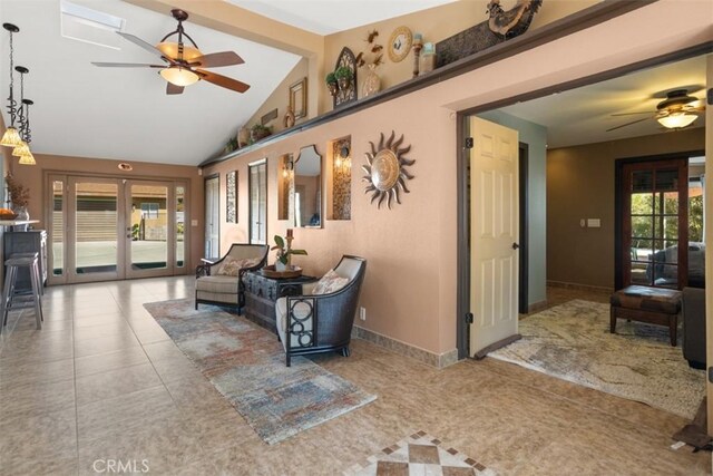 interior space featuring french doors, ceiling fan, and vaulted ceiling