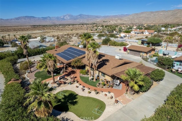 birds eye view of property with a mountain view