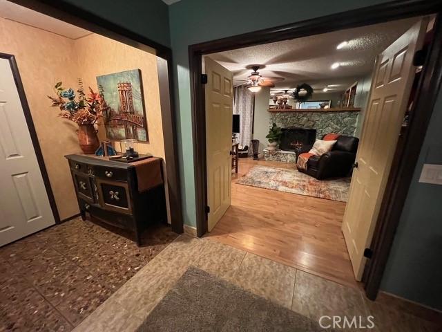 hallway featuring a textured ceiling and light wood-type flooring