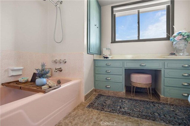 bathroom with vanity, tile patterned floors, and a bathing tub